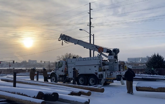 A crew works in Great Falls on a cold winter day.